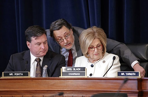 House Budget Committee Chair Diane Black, R-Tenn., right, joined at left by Rep. Todd Rokita, R-Ind., and panel staff member Jim Bates, center, works on the Republican health care bill, on Capitol Hill in Washington, Thursday, March, 16, 2017. 