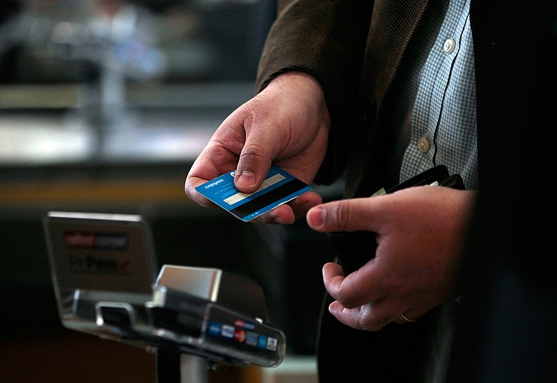 In this Sep. 3, 2015, photo, a man pays with a credit card in a Wal-Mart Ekono supermarket in Santiago, Chile. Some people make a hobby of juggling multiple credit cards to maximize rewards; others just want simplicity. If the idea of chasing credit card rewards as a pastime doesn't appeal to you, using just one credit card is a reasonable choice.