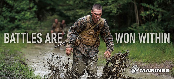This image provided by the U.S. Marine Corps shows a billboard that the Corps will post as part of a new recruitment advertisement campaign, meant to draw millennials by showing Marines as not only strong warriors but good citizens. "Battles Won" is the name of the campaign that includes TV ads and online clips of Marines unloading "Toys for Tots" boxes and real footage of a Marine veteran intercepting a robbery. 