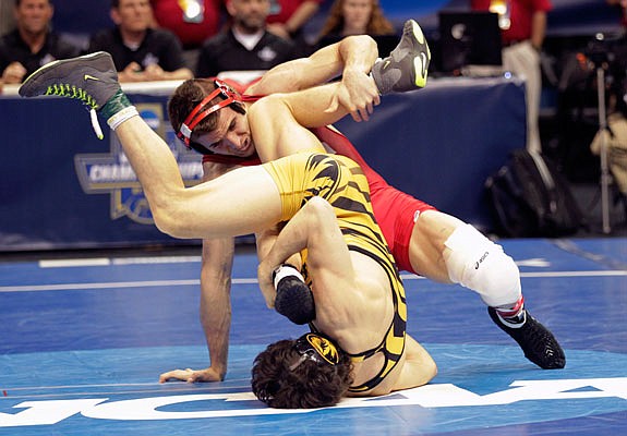 Missouri's Joey Lavalee, (bottom) wrestles Cornell's Dylan Palacio in a 157-pound semifinal match Friday night in St. Louis.