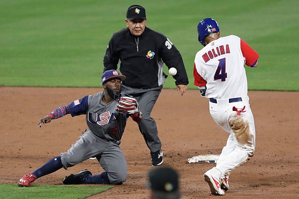 United States infielder Josh Harrison misses the throw as Puerto Rico's Yadier Molina reaches second base on a fielding error by pitcher Marcus Stroman during the third inning of Friday night's second-round World Baseball Classic game in San Diego.
