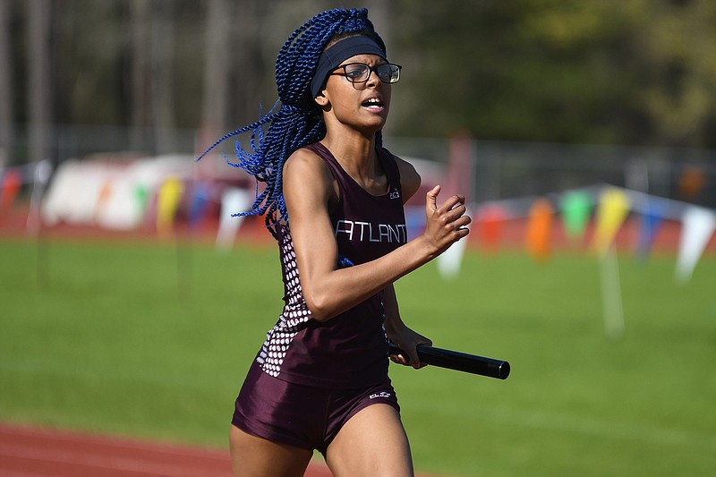 Atlanta's Ri'Chonda Harris competes in the girl's 4x200 on Saturday during the Runnin' Rabb Relays at Rabbit Stadium in Atlanta, Texas.