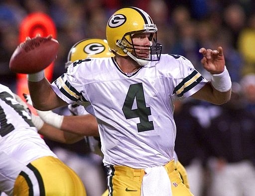 In this Nov. 27, 2000 file photo, Green Bay Packers quarterback Brett Favre (4) looks to pass in the second quarter against the Carolina Panthers in Charlotte, N.C. 