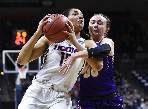 Albany's Mackenzie Trpcic, right, fouls Connecticut's Gabby Williams, left, during the first half of a first round round of a women's college basketball game in the NCAA Tournament, Saturday, March 18, 2017, in Storrs, Conn.