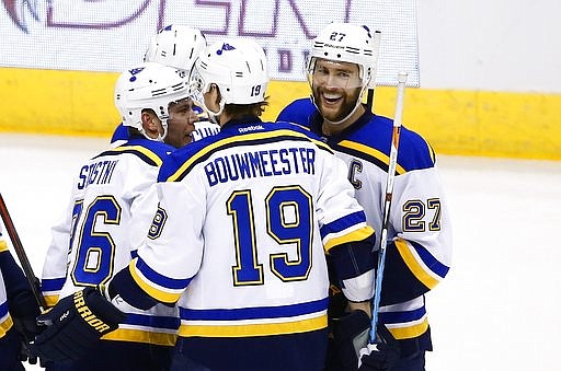 St. Louis Blues defenseman Alex Pietrangelo (27) smiles as he celebrates his goal against the Arizona Coyotes with defenseman Jay Bouwmeester (19) and center Paul Stastny, left, during the first period of an NHL hockey game Saturday, March 18, 2017, in Glendale, Ariz.