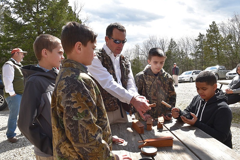 Jason Isabelle, the state turkey biologist with Missouri Department of Conservation, instructs participants of last year's Governor Youth Hunt on how to use a slate call.