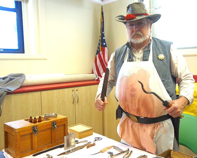 Randy Pauly looms ominously with his reproduction Civil War doctor tools. According to Pauly, a good battlefield surgeon could amputate a limb in three minutes or less.
