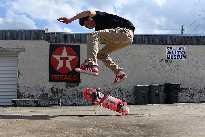 Lucas Chambers takes advantage of Sunday's fine weather to skate next to the Four States Auto Museum in Downtown Texarkana with his friend, Matthew Kennedy.