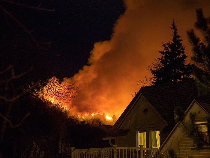 Smoke rises from a wildfire near homes Sunday in Boulder, Colorado. Authorities said the small wildfire burning in the mountains forced people from their homes and is filling the sky with smoke.