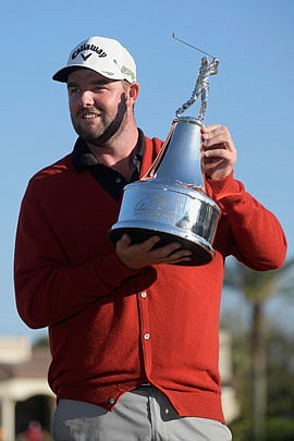 Marc Leishman holds the trophy Sunday after winning the Arnold Palmer Invitational in Orlando, Fla.