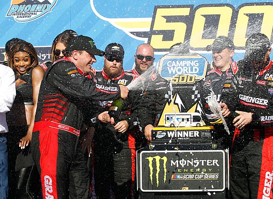 Ryan Newman celebrates with his crew in Victory Lane after winning the NASCAR race Sunday at Phoenix International Raceway in Avondale, Ariz.
