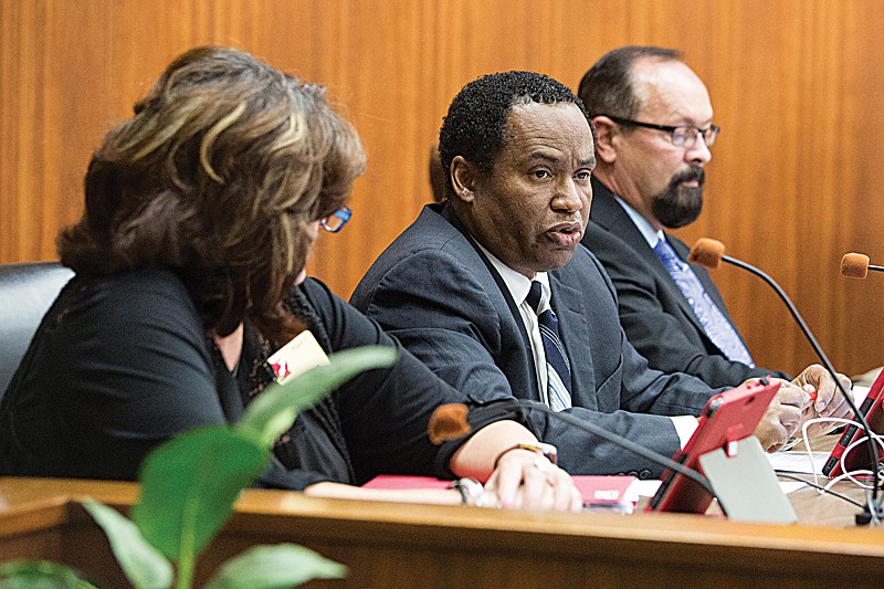 The Texarkana, Ark., Board of Directors passed an ordinance 6-1 Monday night that would prohibit dogs from being kept on chains. Ward 3 Director Laney Harris, center, was the only board member to vote against the ordinance. Harris has been critical of the ordinance because it allows animal control officers, after a warning and a 10-day waiting period, to seize a chained dog without a court order.