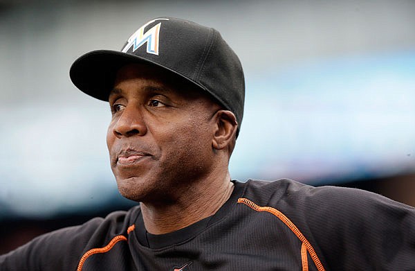 In this June 28, 2016, file photo, Marlins hitting coach Barry Bonds looks from the dugout during a game against the Tigers in Detroit. Bonds has joined the Giants as a special adviser, the team announced Tuesday. Bonds, who hit 762 career home runs, was fired last fall as the hitting coach for the Marlins after one season. 