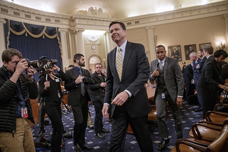 FBI Director James Comey takes a break after three hours of testifying Monday on Capitol Hill in Washington before the House Intelligence Committee hearing on allegations of Trump Tower wiretaps and Russian interference in the 2016 U.S. presidential election.  