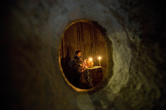 Faithful visit the renovated Edicule in the Church of the Holy Sepulchre, traditionally believed to be the site of the crucifixion of Jesus Christ, on Monday in Jerusalem's old city. A Greek restoration team has completed a historic renovation of the Edicule, the shrine that tradition said houses the cave where Jesus was buried and rose to heaven.