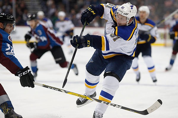 Vladimir Tarasenko of the Blues fires the puck past Avalanche defenseman Francois Beauchemin in the second period of Tuesday night's game in Denver.