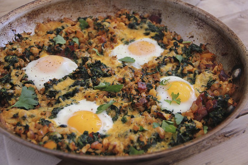 This March 6, 2017 photo shows a country-style breakfast skillet with eggs, bacon and vegetables in Coronado, Calif. This dish is from a recipe by Melissa d'Arabian. 