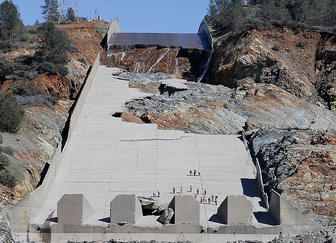 Officials inspect Oroville Dam's crippled spillway last month in Oroville, California. A team of experts is warning of a "very significant risk" if the main spillway of the California dam is not operational again by the next rainy season. 