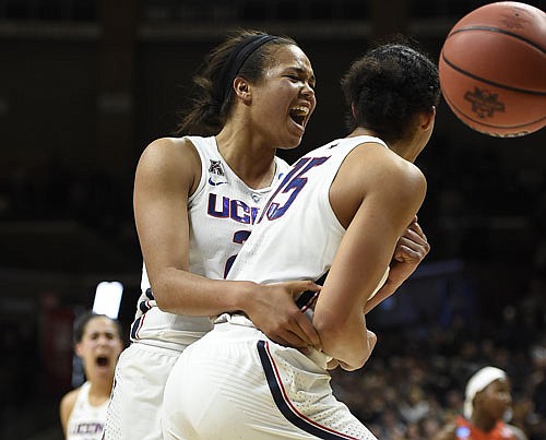 Connecticut teammates Napheesa Collier (left) and Gabby Williams react in the first half of Monday's win against Syracuse in Storrs, Conn.