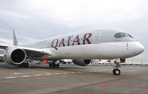 In this Jan. 15, 2015, file photo, a new Qatar Airways Airbus A350 approaches the gate at the airport in Frankfurt, Germany. 