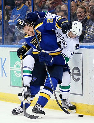 Alexander Steen of the Blues battles for the puck with Luca Sbisa of the Canucks during Thursday night's game in St. Louis. The Blues defeated the Canucks 4-1.