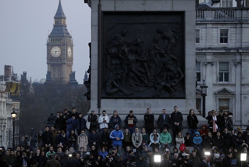 People observe a minutes silence at a vigil for the victims of Wednesday's attack, at Trafalgar Square in London, Thursday, March 23, 2017. The Islamic State group has claimed responsibility for an attack by a man who plowed an SUV into pedestrians and then stabbed a police officer to death on the grounds of Britain's Parliament. Mayor Sadiq Khan called for Londoners to attend a candlelit vigil at Trafalgar Square on Thursday evening in solidarity with the victims and their families and to show that London remains united. 