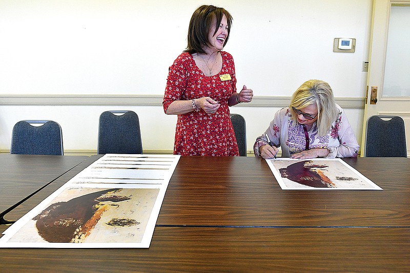  Party with Picassos signature artist Kathi Couch, right, signs prints with Judy Jones at the Regional Arts Center. 