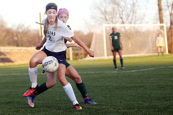 Hannah Loethen of Helias receives the ball in front of a St. Joseph's Academy defender during the first half of Thursday's game at the 179 Soccer Park. St. Joseph's Academy defeated Helias 6-1.