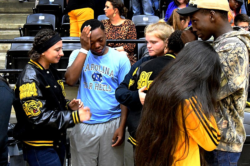 Mount Pleasant students, community members and loved ones of Angelica Beard, who was killed Thursday night in a fatal vehicle accident, on U.S. Highway 271, mourn and pray together during a memorial vigil Friday at Mount Pleasant High School. 