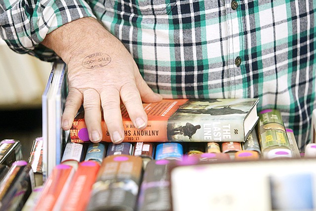 A patron browses through books March 8 during the first day of the annual used book sale hosted by the Missouri River Regional Library at the Knights of Columbus. The library partners with Adult Basic Literacy Education to host the event, the proceeds of which benefit both MRRL and ABLE.