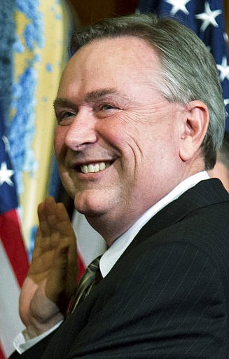 In this Jan. 3, 2013, file photo, Rep. Steve Stockman, R-Texas, right, participates in a mock swearing-in ceremony in Washington. Former Texas Rep. Stockman is accused of spending money meant for charity on himself and contributions to his campaign.