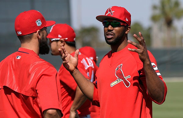 In this Feb. 17 file photo, Cardinals outfielder Dexter Fowler talks with Matt Carpenter during a spring training workout in Jupiter, Fla. Fowler jumped from World Series champion Cubs to rival St. Louis during the offseason.