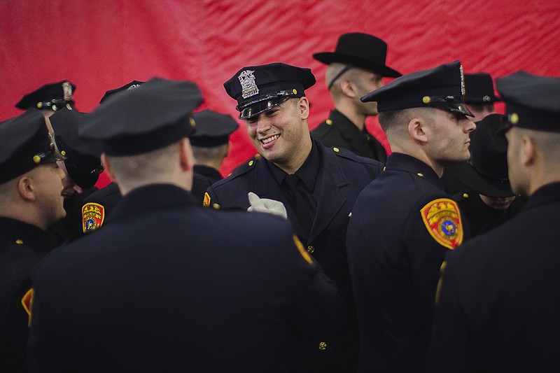 Matias Ferreira, center, celebrates Friday with his colleagues during their graduation from the Suffolk County Police Department Academy at the Health, Sports and Education Center in Suffolk, N.Y.