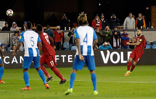 Clint Dempsey (right) of the United States watches his free kick head toward the net for a goal during the second half of Friday night's game against Honduras during World Cup qualifying in San Jose, Calif.