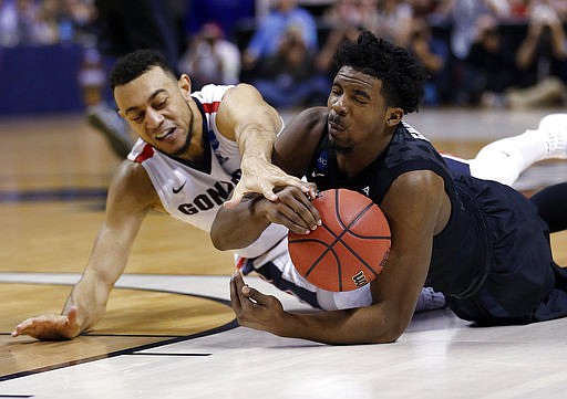Xavier guard Quentin Goodin, right, grabs a loose ball next to Gonzaga guard Nigel Williams-Goss during the first half of an NCAA Tournament college basketball regional final game Saturday, March 25, 2017, in San Jose, Calif. 