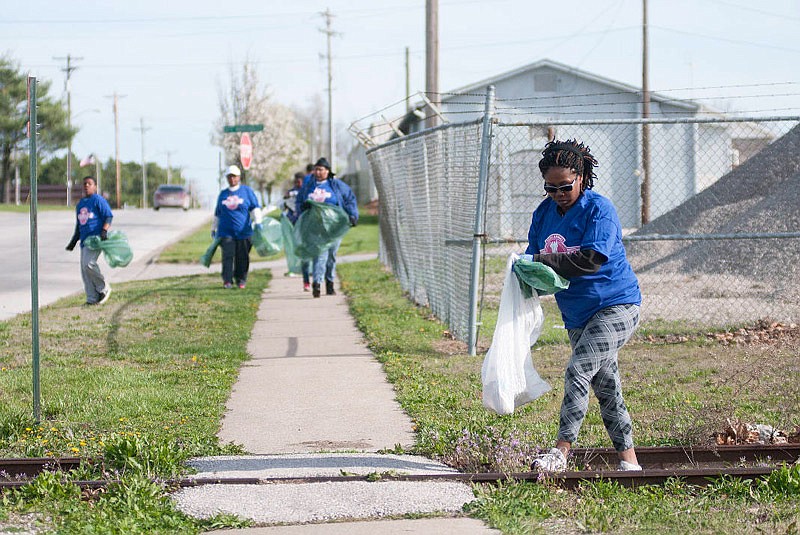 Deniece Vaughn-McCaleb, of Fulton, and members of Second Christian Church pick up trash on Westminster Avenue during the 2015 Clean Sweep.