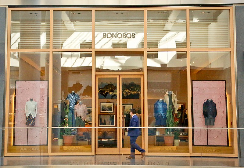 In this Monday, March 20, 2017, photo, a man walks by the Bonobos Guideshop in New York's Financial District. More shoppers are looking to social media or curated selections for fashion inspiration. That adds to the woes of mall-based stores, as people are already buying fewer clothes, spending online or at discounters when they do, and demanding more personal and convenient ways to buy.