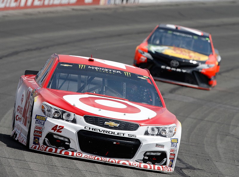 Kyle Larson, left, leads Martin Truex Jr., right, to take the first stage (the first 60 laps) of the NASCAR Cup Series auto race at Auto Club Speedway in Fontana, Calif., Sunday, March 26, 2017. 