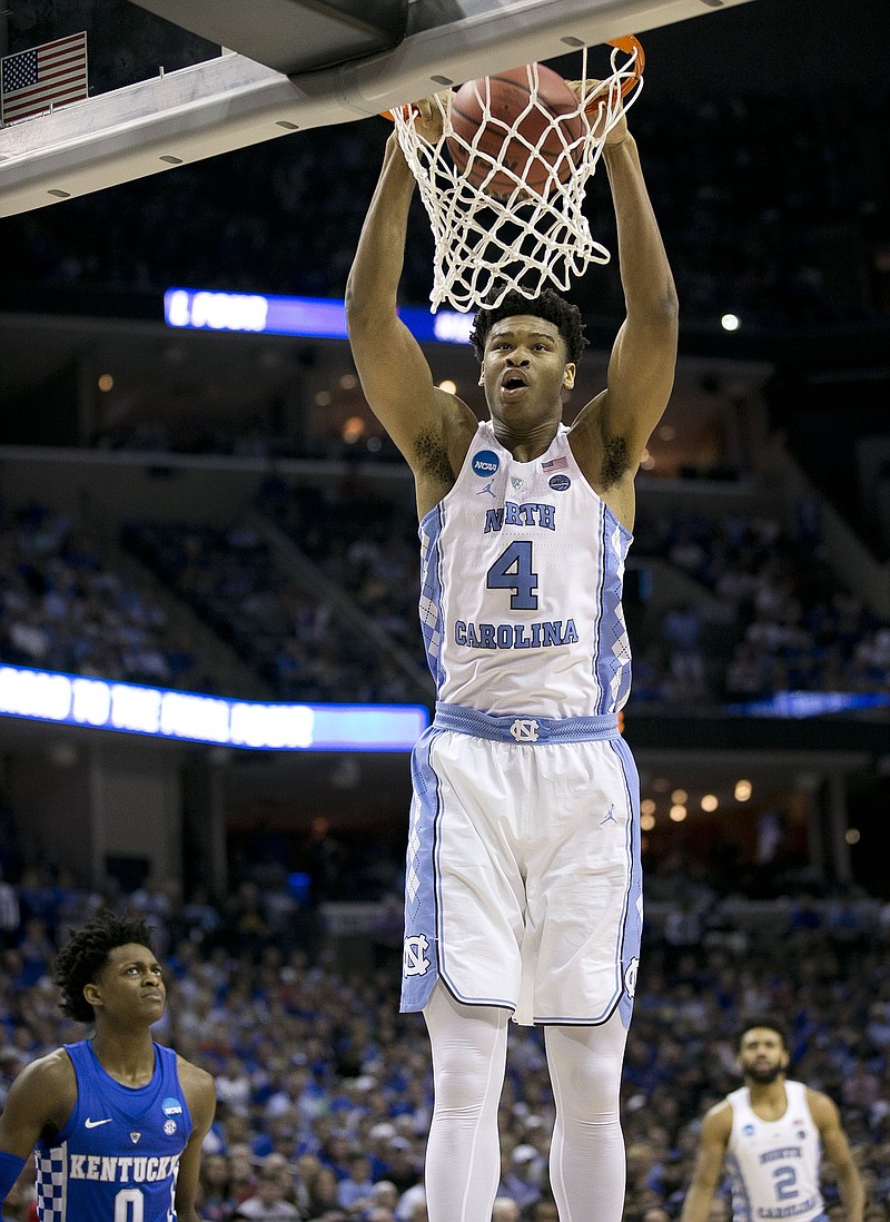 North Carolina's Isaiah Hicks (4) gets a dunk over Kentucky's De'Aaron Fox (0) during the first half of the NCAA Tournament South Regional final on Sunday, March 26, 2017 at FedExForum in Memphis, Tenn.