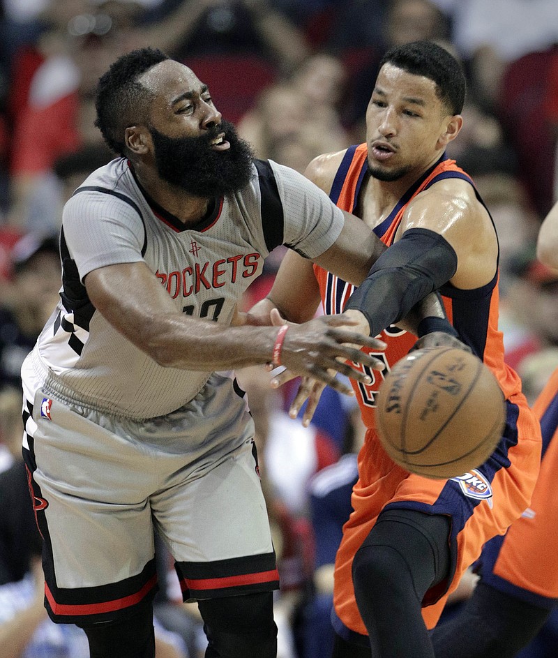 Houston Rockets' James Harden (13) has the ball knocked away by Oklahoma City Thunder's Andre Roberson (21) in an NBA basketball game in Houston, Sunday, March 26, 2017. 