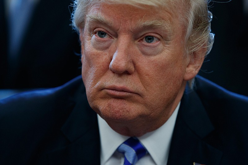 President Donald Trump pauses in the Oval Office of the White House in Washington Friday, March 24, 2017, during an announcement on the approval of a permit to build the Keystone XL pipeline, clearing the way for the $8 billion project. 