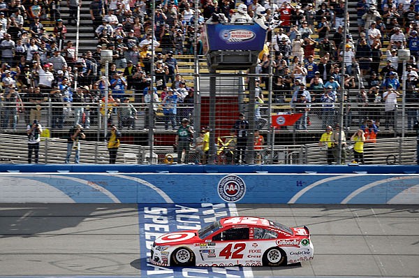 Kyle Larson crosses the finish line to win Sunday's NASCAR Cup Series race at Auto Club Speedway in Fontana, Calif.