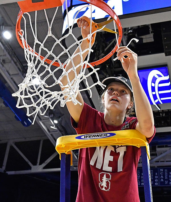 Stanford's Brittany McPhee cuts off a piece of the net after Sunday's win against Notre Dame in the Lexington regional final of the women's NCAA Tournament in Lexington, Ky.