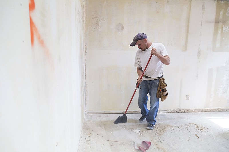  Contractor Jeffrey Gearlds sweeps Monday after removing molding at the new Randy Sams Outreach Shelter office. Moving the administrative offices from the main shelter will allow the shelter to house more people and provide central heat and air conditioning.