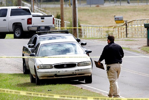 Investigators work at the scene Monday, March 27, 2017, where a Tecumseh, Okla. police officer was shot during a traffic stop overnight. Officer Justin Terney died Monday morning after undergoing surgery overnight, Tecumseh Assistant Police Chief J.R. Kidney said. The suspect was also shot and was in intensive care Monday morning, Kidney said. 