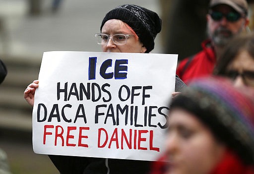 In this Feb. 17, 2017 file photo, a protester holds a sign that reads "ICE Hands Off DACA Families Free Daniel," during a demonstration in front of the federal courthouse in Seattle. On Friday, March 24 2017, a federal judge upheld a decision not to release Daniel Ramirez Medina, a Mexican man who was arrested near Seattle, despite his participation in a program designed to protect those brought to the U.S. illegally as children, saying Ramirez should challenge his detention in immigration court.