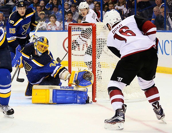 Blues goaltender Jake Allen makes a glove save on a shot by Coyotes left wing Max Domi in the second period of Monday's game in St. Louis.