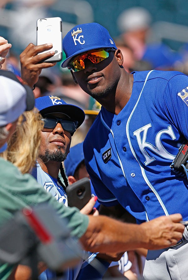 Royals right fielder Jorge Soler poses for a picture with a fan prior to a spring training game against the Indians earlier this month in Goodyear, Ariz.