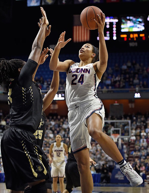 In this March 5 file photo, Connecticut's Napheesa Collier shoots over Central Florida's Joslyn Massey during the first half of a game in the American Athletic Conference tournament semifinals at Mohegan Sun Arena in Uncasville, Conn. Collier was selected to the Associated Press women's basketball All-America first team.