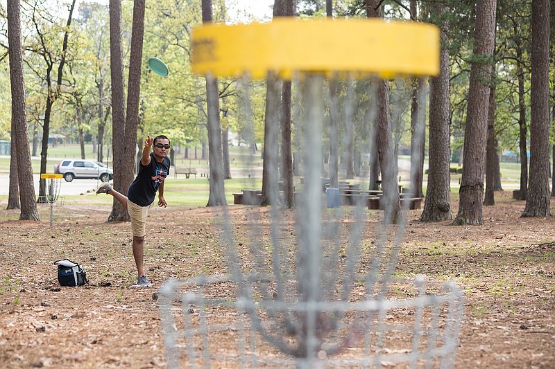 Jay Patel plays disc golf Tuesday with friends at Spring Lake Park. A group of students from Queen City High School had the day off for state testing, so they decided to come to Texarkana to play disc golf. 
